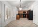 Kitchen features dark wood cabinets, black appliances, and tile floors at 4554 W Whitten Ct, Chandler, AZ 85226