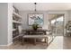 Bright dining room with a farmhouse table and built-in shelving at 7625 W Whitehorn Trl, Peoria, AZ 85383