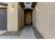 Front entry of the house with a brown door and stone pathway at 7625 W Whitehorn Trl, Peoria, AZ 85383