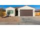 New single-story home with attached garage and desert landscaping at 940 E Penny Ln, Casa Grande, AZ 85122