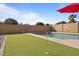 Backyard with artificial turf, a pool, and a block wall at 965 W Saguaro Ln, San Tan Valley, AZ 85143