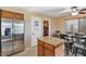 Kitchen with island, stainless steel appliances, and tile floors at 965 W Saguaro Ln, San Tan Valley, AZ 85143