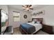 Bedroom with a double bed, a large TV, and wood nightstands at 9736 E Thatcher Ave, Mesa, AZ 85212