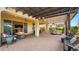 Outdoor kitchen and seating area under covered patio at 9736 E Thatcher Ave, Mesa, AZ 85212