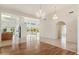 Bright dining room with hardwood floors and chandelier, open to kitchen at 13026 W Foxfire Dr, Sun City West, AZ 85375