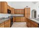 Spacious kitchen with wood cabinets and granite countertops at 13026 W Foxfire Dr, Sun City West, AZ 85375