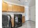 Laundry room with washer, dryer and cabinets at 13026 W Foxfire Dr, Sun City West, AZ 85375