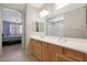 Double vanity bathroom with large mirror and shower at 15072 W Mckinley St, Goodyear, AZ 85338