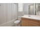 Bathroom with tub, toilet, and light wood vanity at 15072 W Mckinley St, Goodyear, AZ 85338