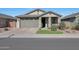 Single-story home with a two-car garage and landscaped front yard at 15072 W Mckinley St, Goodyear, AZ 85338