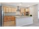 Modern kitchen with light wood cabinets, granite countertops, and stainless steel appliances at 15072 W Mckinley St, Goodyear, AZ 85338