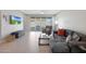 Comfortable living room with gray sectional sofa and access to the backyard at 15072 W Mckinley St, Goodyear, AZ 85338