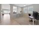 Home office with a desk and view into the dining and living areas at 15072 W Mckinley St, Goodyear, AZ 85338