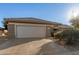 One story home with a two-car garage and desert landscaping at 16319 W Mission Cove Ln, Surprise, AZ 85374