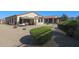 Spacious backyard with patio, artificial turf, and mature shrubs at 17915 W Silver Fox Way, Goodyear, AZ 85338