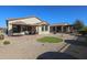 Relaxing backyard with patio, artificial turf, and umbrellas at 17915 W Silver Fox Way, Goodyear, AZ 85338