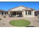 Backyard features a patio, artificial turf, and a large window at 17915 W Silver Fox Way, Goodyear, AZ 85338