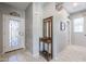 Entryway with tile flooring, coat rack, and access to office and bath at 17915 W Silver Fox Way, Goodyear, AZ 85338