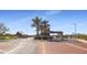 Gated community entrance with guard house and palm trees at 17915 W Silver Fox Way, Goodyear, AZ 85338