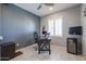 Home office with built-in wine cooler and large desk at 17915 W Silver Fox Way, Goodyear, AZ 85338