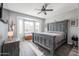 Main bedroom featuring a large bed and ceiling fan at 17915 W Silver Fox Way, Goodyear, AZ 85338