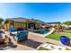 Inviting backyard oasis with a sparkling pool, patio furniture, and a pergola at 18174 W Wind Song Ave, Goodyear, AZ 85338
