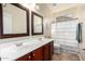 Bathroom with double vanity and shower/tub combo at 18174 W Wind Song Ave, Goodyear, AZ 85338