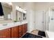 Bathroom with double vanity, shower, and tile floors at 18174 W Wind Song Ave, Goodyear, AZ 85338