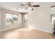 Bright bedroom with tile floors and ceiling fan at 18174 W Wind Song Ave, Goodyear, AZ 85338