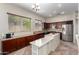 Spacious kitchen with island, stainless steel appliances, and ample cabinetry at 18174 W Wind Song Ave, Goodyear, AZ 85338
