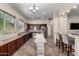 Well-equipped kitchen featuring dark wood cabinets and an island at 18174 W Wind Song Ave, Goodyear, AZ 85338