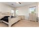 Main bedroom with large bed, dresser, and tile floors at 18174 W Wind Song Ave, Goodyear, AZ 85338
