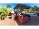Outdoor kitchen with grill, bar seating, and tile counters at 18174 W Wind Song Ave, Goodyear, AZ 85338