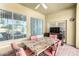 Covered patio features a table, chairs, and a TV at 18174 W Wind Song Ave, Goodyear, AZ 85338