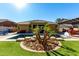 Inviting pool and spa surrounded by a lush landscape at 18174 W Wind Song Ave, Goodyear, AZ 85338