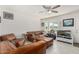 Living room featuring brown leather furniture and a large window at 1950 E Paradise Ln, Phoenix, AZ 85022