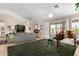 Living room with a view to the backyard and grand piano at 24230 S Desert Vale Dr, Sun Lakes, AZ 85248