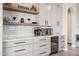 Kitchen features floating shelves, wine cooler and coffee bar at 2705 W Wildwood Dr, Phoenix, AZ 85045