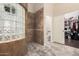 Bathroom with glass block shower, tile flooring, and walk-in closet at 3205 E Gemini Ct, Chandler, AZ 85249