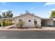 Light pink single-wide mobile home with carport and landscaping at 3330 E Main St # 111, Mesa, AZ 85213