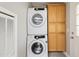 Stackable washer and dryer with wood cabinets at 3330 E Main St # 111, Mesa, AZ 85213
