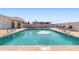 Community swimming pool with lounge chairs and umbrellas at 3330 E Main St # 111, Mesa, AZ 85213