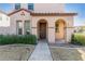 Tan two-story house with arched entryway and landscaping at 3702 E Dogwood Dr, Chandler, AZ 85286