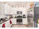 Kitchen with white cabinets, granite counters, and stainless steel appliances at 3702 E Dogwood Dr, Chandler, AZ 85286