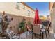 Private patio with seating area, umbrella, and small fountain at 3702 E Dogwood Dr, Chandler, AZ 85286