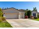 Two-car garage and landscaped front yard with flowering bushes at 4577 S Ambrosia Dr, Chandler, AZ 85248