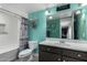 Bathroom with teal walls, tub, and dark vanity at 5520 N 5Th Ln, Phoenix, AZ 85013