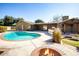 Relaxing pool area with fire pit and outdoor kitchen at 618 W Palmaire Ave, Phoenix, AZ 85021