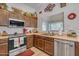 Bright kitchen featuring stainless steel appliances and wood cabinets at 6441 S Granite Dr, Chandler, AZ 85249