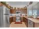 Kitchen with dark wood cabinets and stainless steel appliances at 6441 S Granite Dr, Chandler, AZ 85249